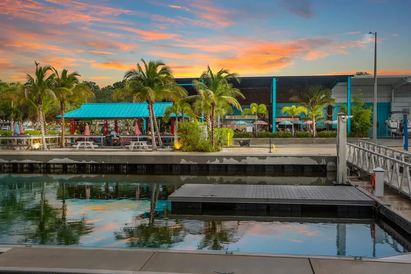  Yacht Photos Pics Tropical marina at sunset with palm trees and vibrant sky, featuring a docked Carver 356 Aft Cabin.