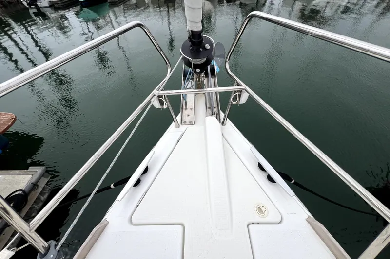 Knot Behaving Yacht Photos Pics Bow view of 2014 Jeanneau Sun Odyssey 379 sailboat docked in calm marina waters.