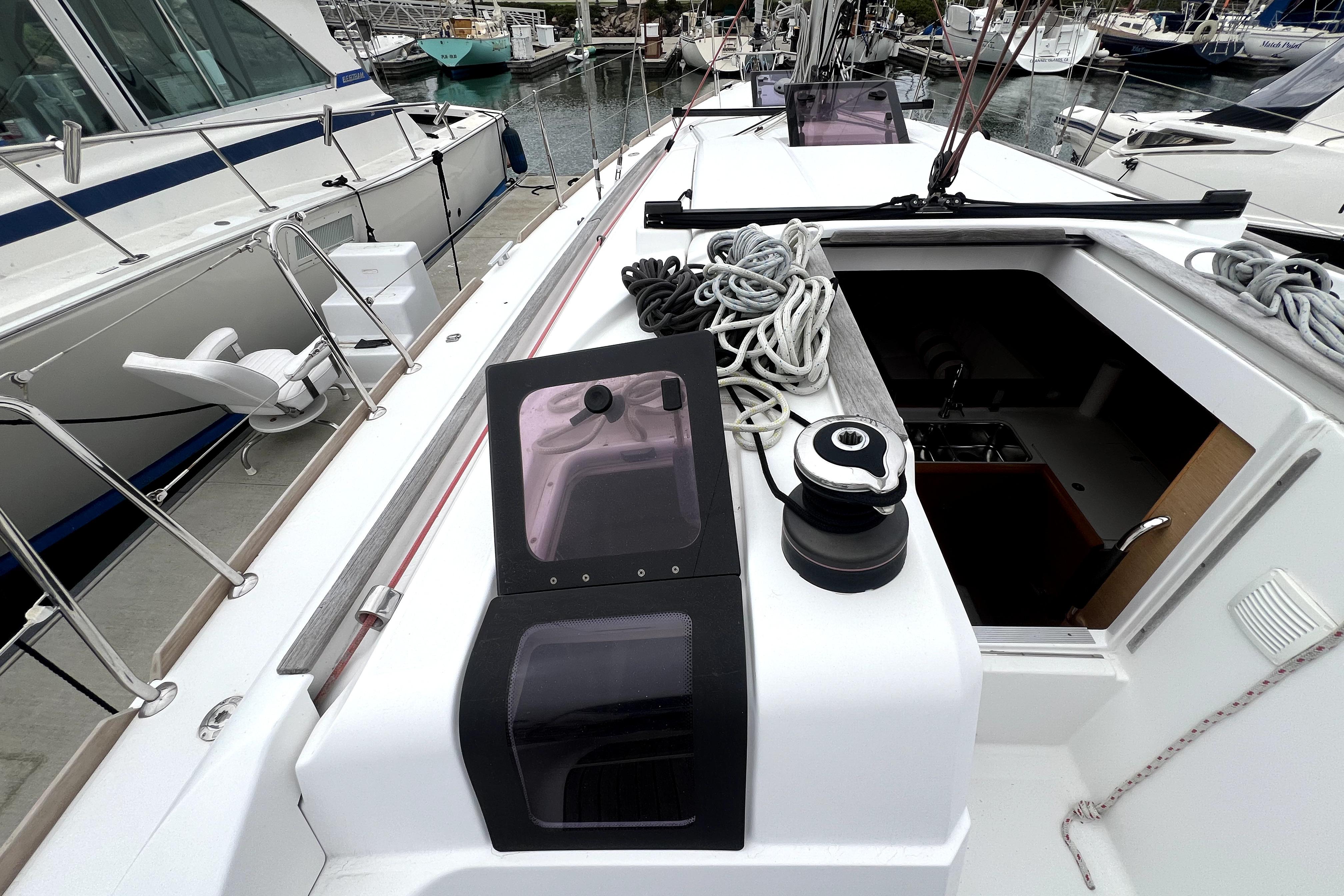 2014 Jeanneau Sun Odyssey 379 sailboat deck with ropes and winch in marina.
