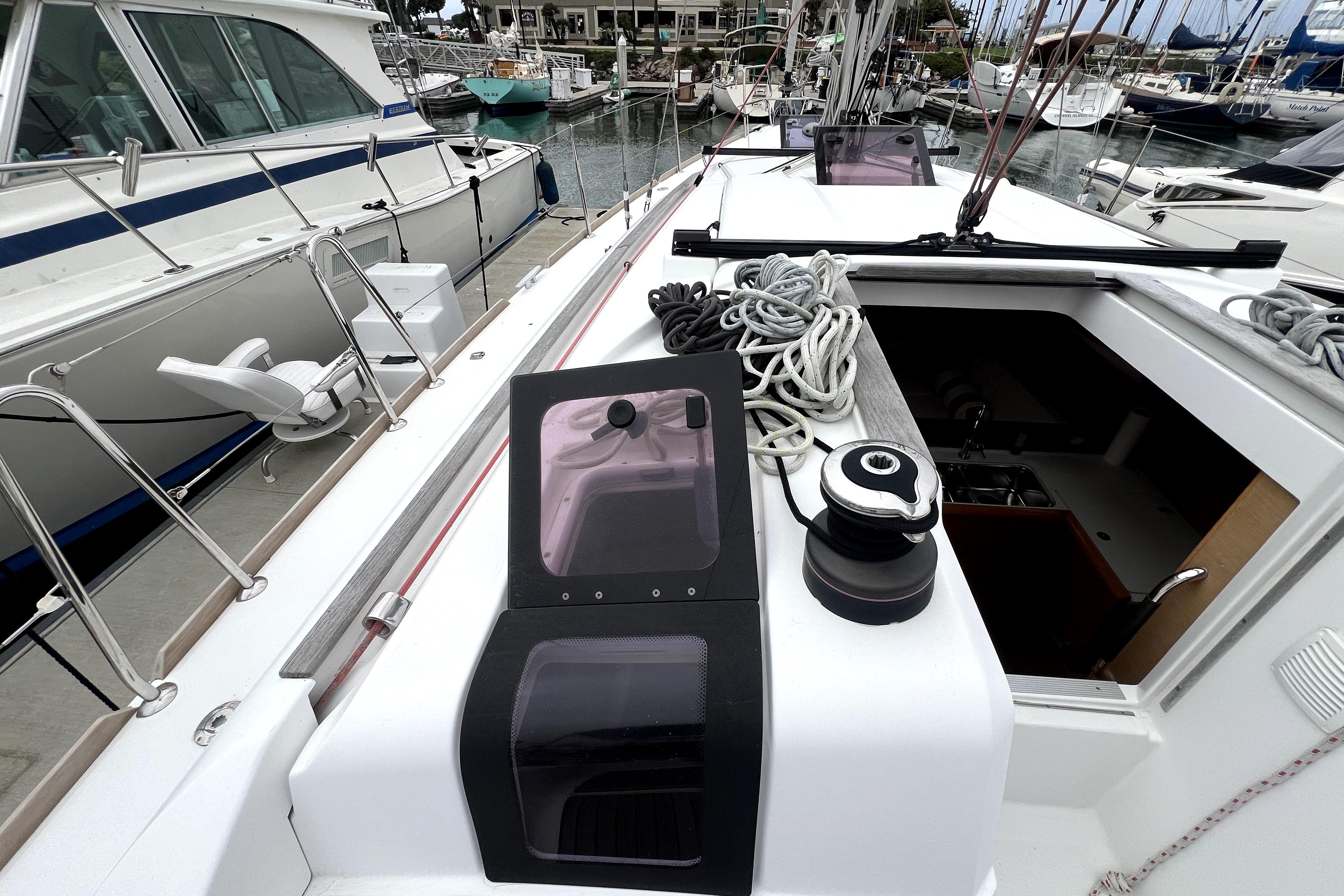 2014 Jeanneau Sun Odyssey 379 sailboat deck with ropes and winch in marina.