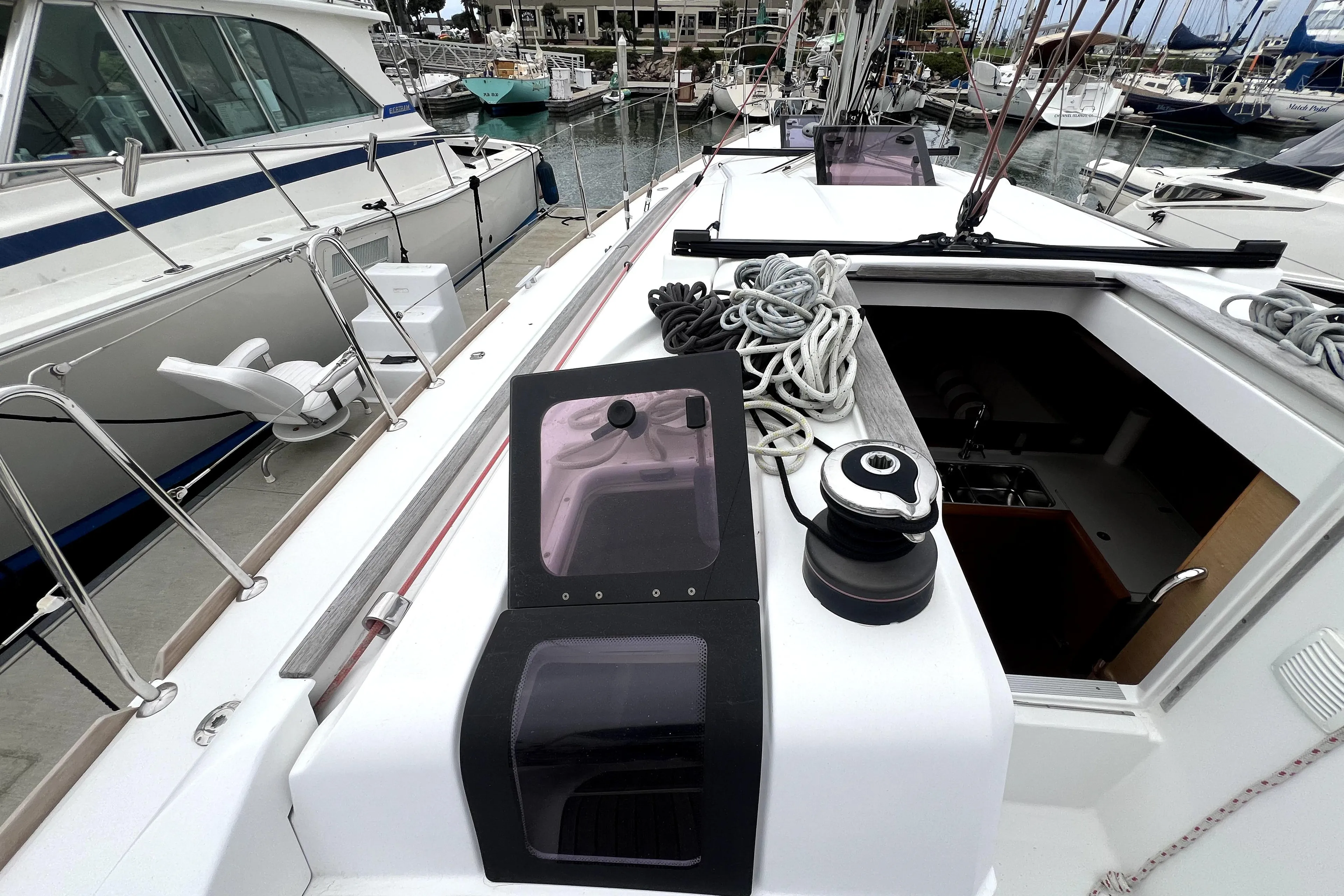 2014 Jeanneau Sun Odyssey 379 sailboat deck with ropes and winch in marina.