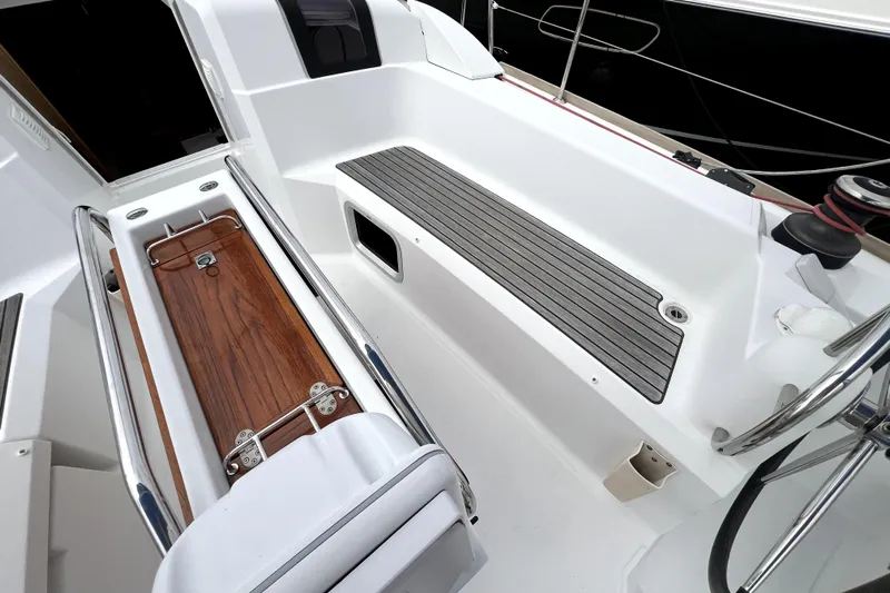 Knot Behaving Yacht Photos Pics Cockpit of 2014 Jeanneau Sun Odyssey 379 sailboat with seating and storage.