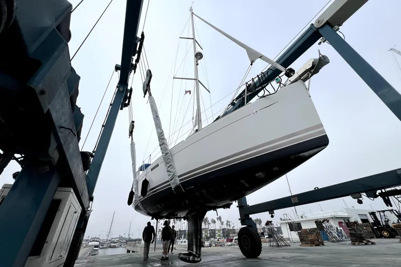 Knot Behaving Yacht Photos Pics 2014 Jeanneau Sun Odyssey 379 sailboat being lifted at a marina.