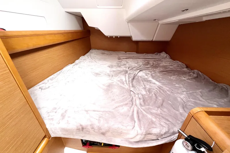 Knot Behaving Yacht Photos Pics Cozy cabin interior of 2014 Jeanneau Sun Odyssey 379 sailboat with plush bedding.