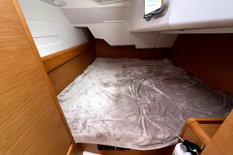 Knot Behaving Yacht Photos Pics Cozy cabin interior of 2014 Jeanneau Sun Odyssey 379 sailboat with plush bedding.