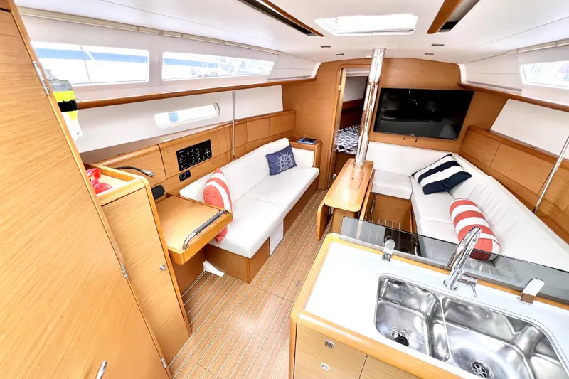Knot Behaving Yacht Photos Pics Luxurious interior of 2014 Jeanneau Sun Odyssey 379 sailboat with modern amenities.