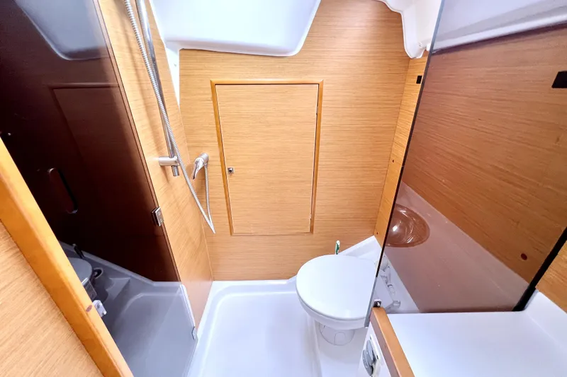 Knot Behaving Yacht Photos Pics Bathroom interior of 2014 Jeanneau Sun Odyssey 379 yacht, featuring modern fixtures and wood paneling.