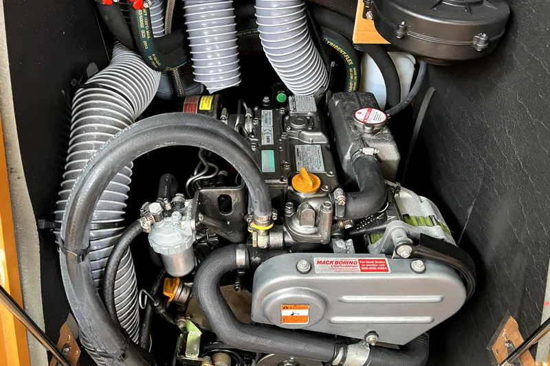 Knot Behaving Yacht Photos Pics Engine compartment of a 2014 Jeanneau Sun Odyssey 379 sailboat, showcasing detailed components.