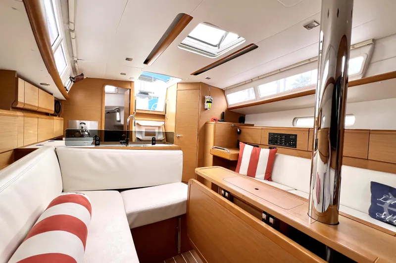 Knot Behaving Yacht Photos Pics 2014 Jeanneau Sun Odyssey 379 interior with modern kitchen and cozy seating area.