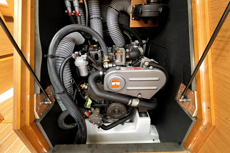 Knot Behaving Yacht Photos Pics Engine compartment of 2014 Jeanneau Sun Odyssey 379 sailboat, showcasing detailed mechanical components.