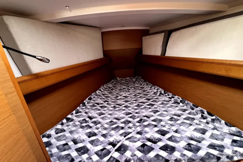 Knot Behaving Yacht Photos Pics Cozy cabin interior of 2014 Jeanneau Sun Odyssey 379 sailboat with patterned bedding.