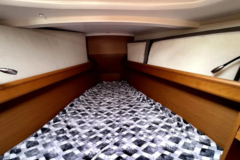 Knot Behaving Yacht Photos Pics Cozy cabin interior of 2014 Jeanneau Sun Odyssey 379 sailboat with patterned bedding.