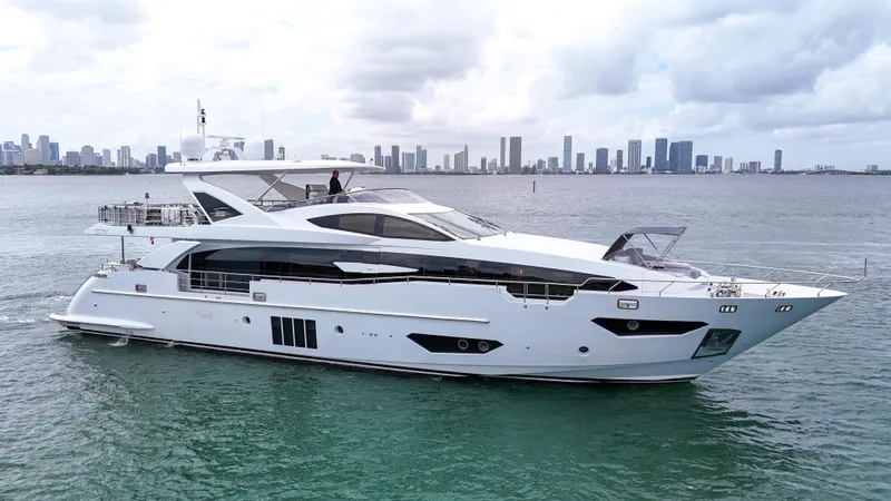  Yacht Photos Pics Luxurious 2017 Azimut 95 Raised Pilothouse yacht cruising near a city skyline.