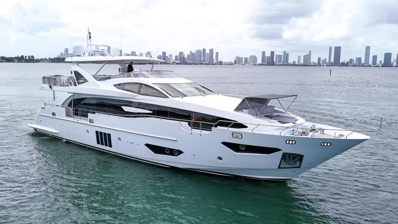  Yacht Photos Pics Luxurious 2017 Azimut 95 Raised Pilothouse yacht cruising near city skyline.