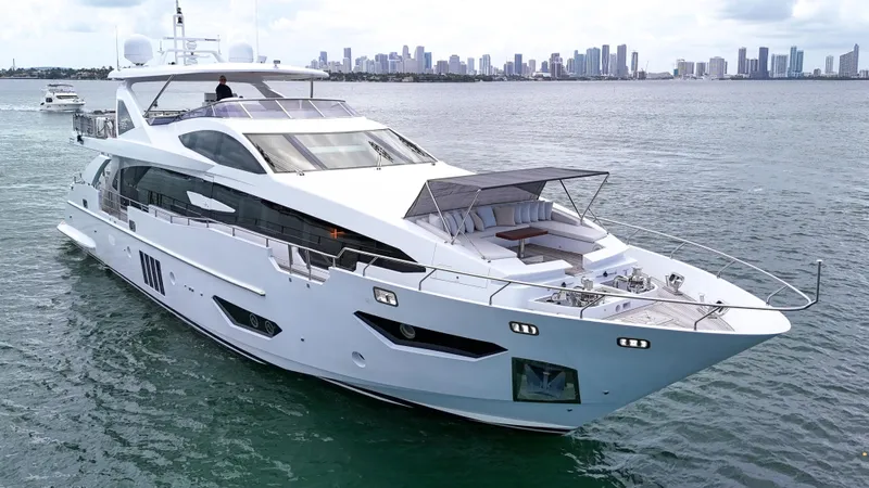  Yacht Photos Pics Luxurious 2017 Azimut 95 Raised Pilothouse yacht cruising near city skyline.