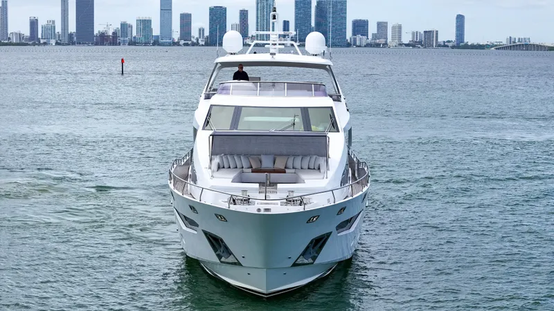 Yacht Photos Pics Luxurious 2017 Azimut 95 Raised Pilothouse yacht cruising near city skyline.