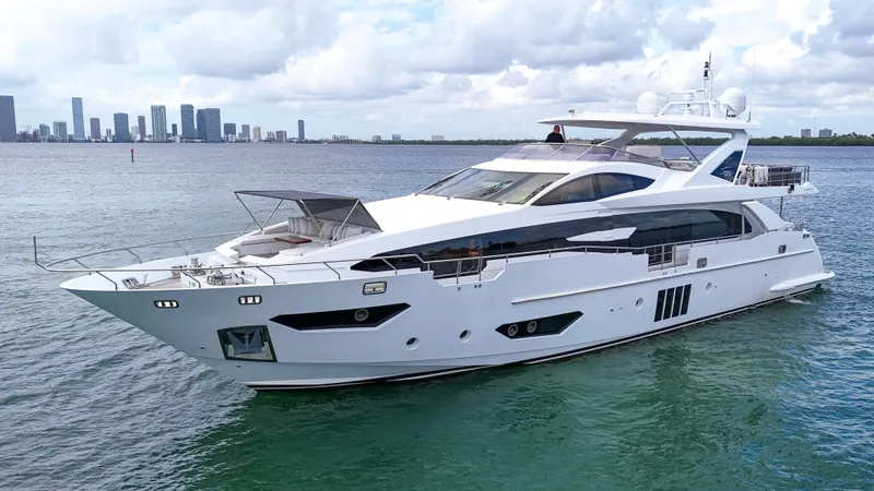  Yacht Photos Pics Luxury 2017 Azimut 95 Raised Pilothouse yacht cruising near city skyline.