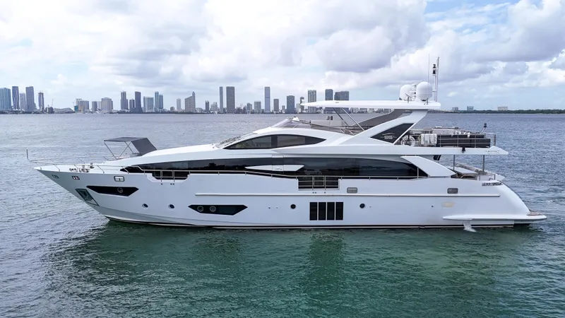  Yacht Photos Pics Luxury 2017 Azimut 95 Raised Pilothouse yacht on calm water with city skyline.