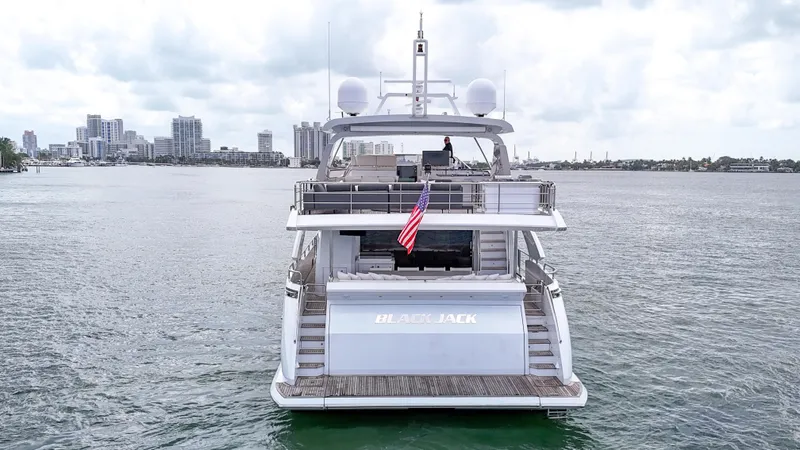  Yacht Photos Pics 2017 Azimut 95 Raised Pilothouse yacht on water with city skyline background.
