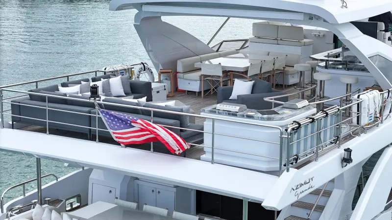  Yacht Photos Pics Luxurious 2017 Azimut 95 Raised Pilothouse yacht with spacious deck and American flag.