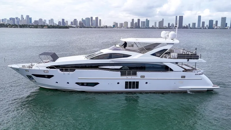  Yacht Photos Pics Luxury 2017 Azimut 95 Raised Pilothouse yacht on water with city skyline backdrop.