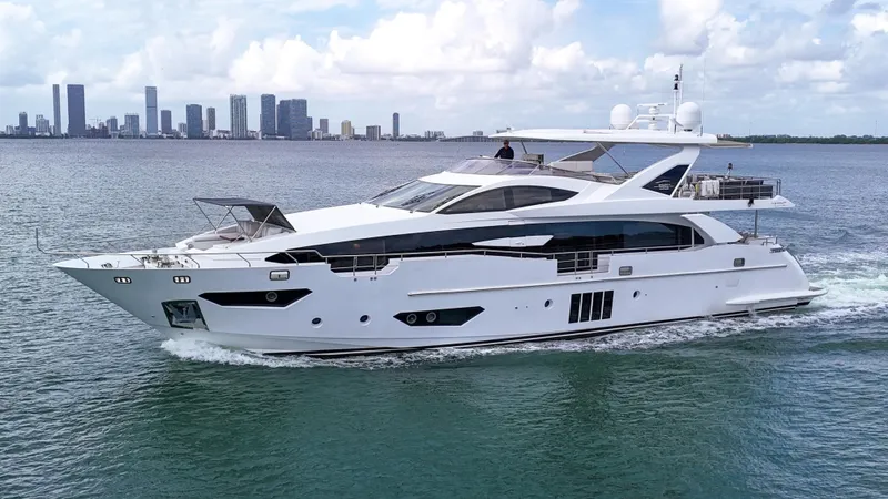  Yacht Photos Pics Luxury 2017 Azimut 95 Raised Pilothouse yacht cruising near city skyline.