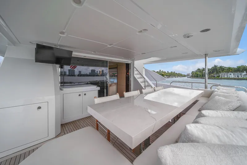 Yacht Photos Pics Luxurious 2017 Azimut 95 Raised Pilothouse yacht deck with elegant seating and dining area.