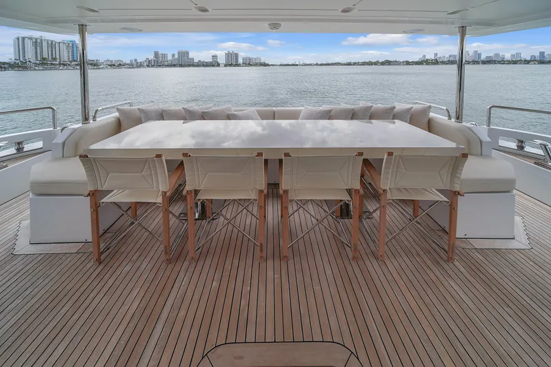  Yacht Photos Pics Azimut 95 Raised Pilothouse 2017 yacht deck with dining area overlooking water.