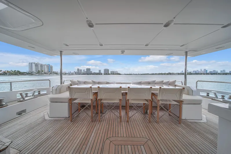  Yacht Photos Pics Luxurious 2017 Azimut 95 Raised Pilothouse yacht deck with elegant seating and scenic waterfront view.