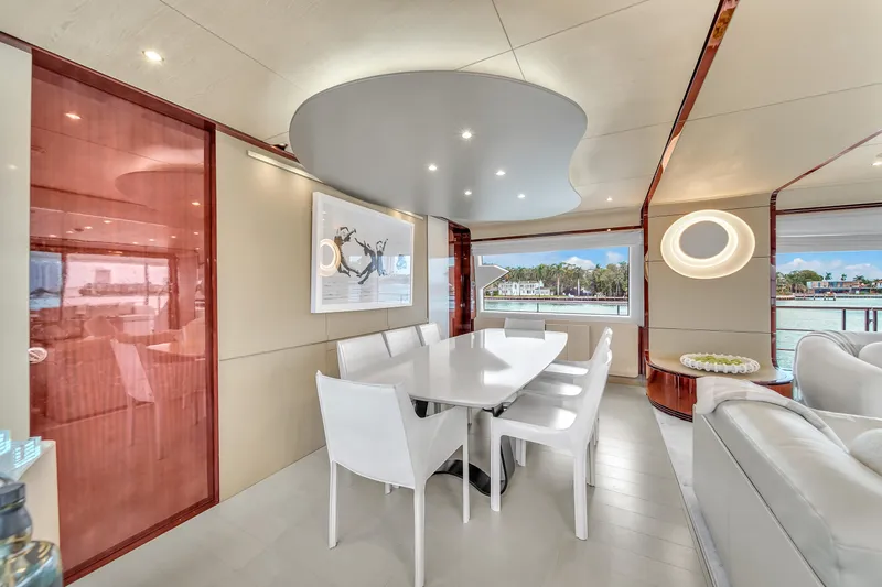  Yacht Photos Pics Luxurious interior of 2017 Azimut 95 Raised Pilothouse yacht with modern dining area.