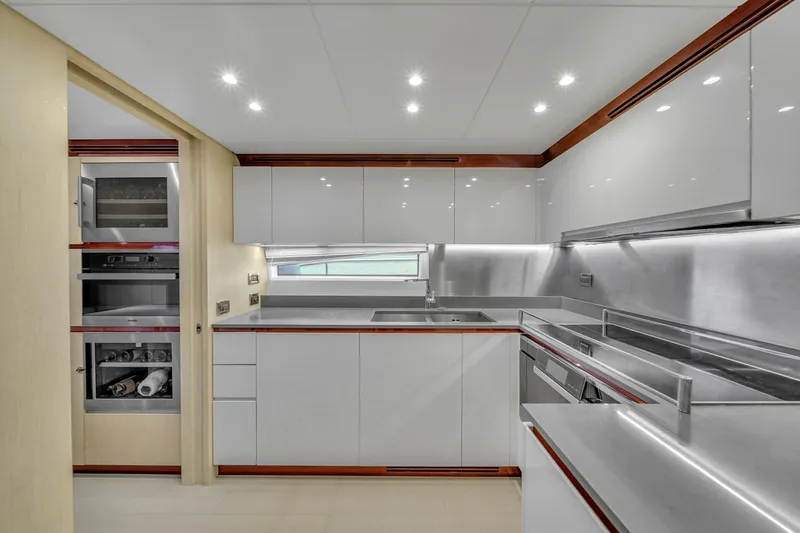  Yacht Photos Pics Modern kitchen interior on 2017 Azimut 95 Raised Pilothouse yacht, featuring sleek cabinetry and appliances.