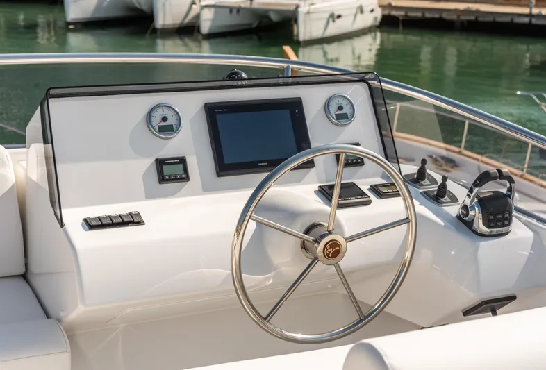  Yacht Photos Pics 2025 Sasga Yachts Menorquin 55 Flybridge helm with steering wheel and navigation controls.