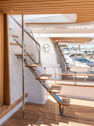  Yacht Photos Pics 2025 Sasga Yachts Menorquin 55 Flybridge, elegant wooden deck and sleek metal staircase.