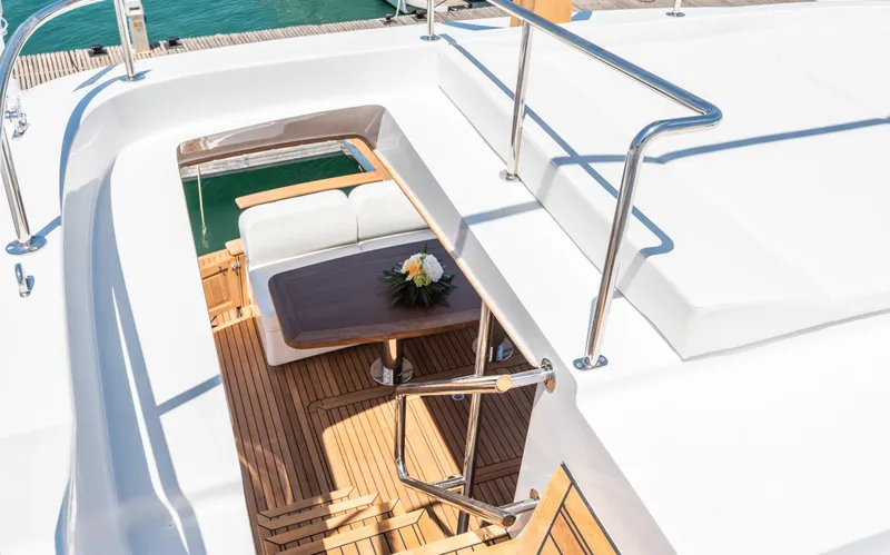  Yacht Photos Pics 2025 Sasga Yachts Menorquin 55 Flybridge, elegant deck view with seating and table arrangement.