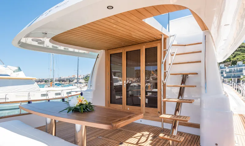  Yacht Photos Pics 2025 Sasga Yachts Menorquin 55 Flybridge with elegant wooden deck and outdoor seating area.