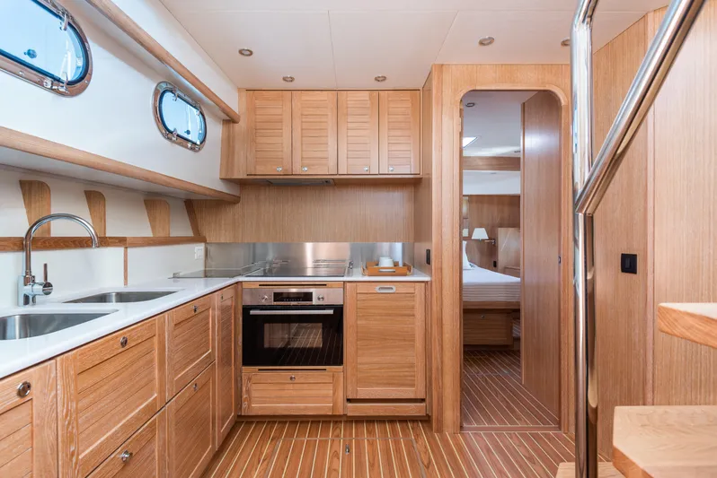  Yacht Photos Pics Luxurious kitchen interior of 2025 Sasga Yachts Menorquin 55 Flybridge with wood finish.