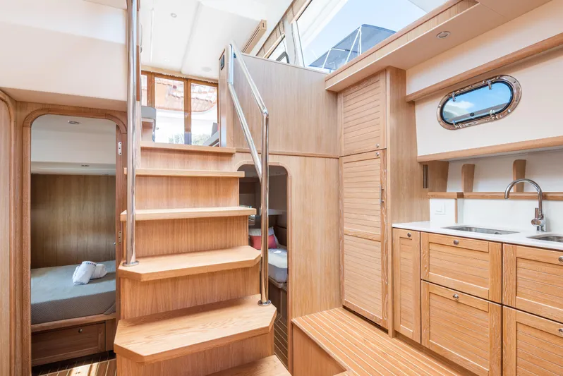  Yacht Photos Pics Interior of 2025 Sasga Yachts Menorquin 55 Flybridge, featuring wooden stairs and cabinetry.