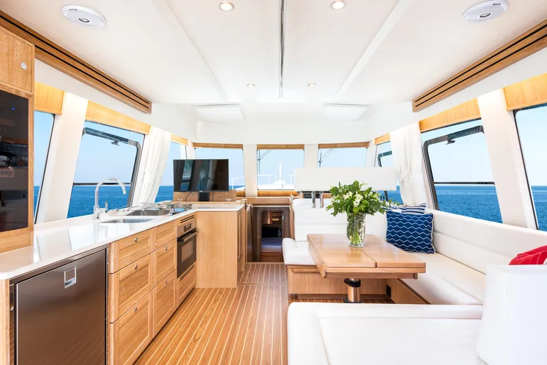  Yacht Photos Pics Luxurious interior of 2025 Sasga Yachts Menorquin 55 Flybridge with modern kitchen and seating area.