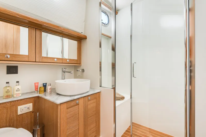  Yacht Photos Pics Luxurious bathroom in 2025 Sasga Yachts Menorquin 55 Flybridge with wooden cabinetry and modern fixtures.