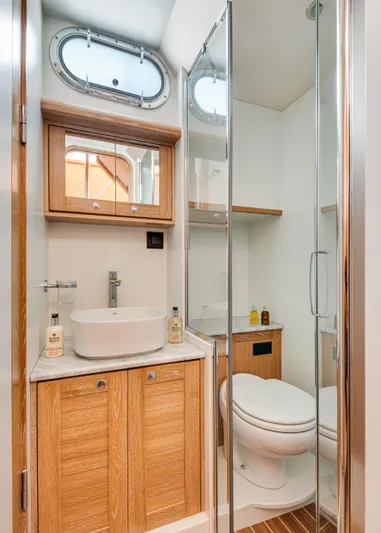  Yacht Photos Pics 2025 Sasga Yachts Menorquin 55 Flybridge bathroom with modern fixtures and wooden cabinetry.