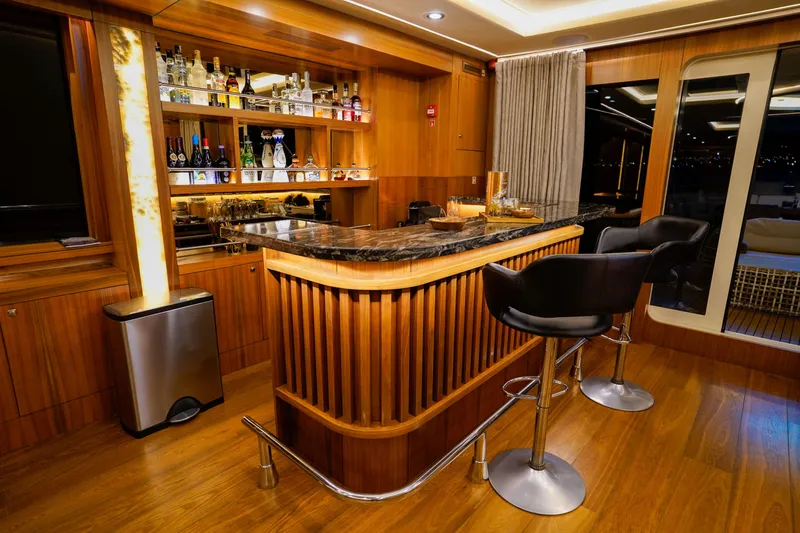 Aresteas Yacht Photos Pics Luxurious yacht bar interior with wooden finish, marble countertop, and modern bar stools, 2017 Yildizlar.