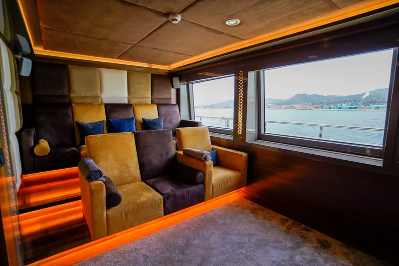 Aresteas Yacht Photos Pics Luxurious yacht interior with plush seating, ambient lighting, and scenic ocean view through large windows.