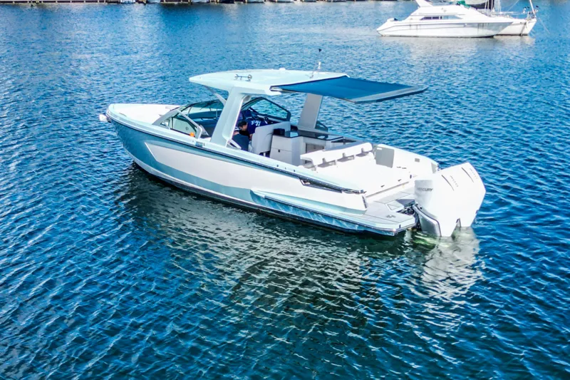  Yacht Photos Pics 2022 Aviara AV32 OB boat on calm water, featuring sleek design and modern amenities.