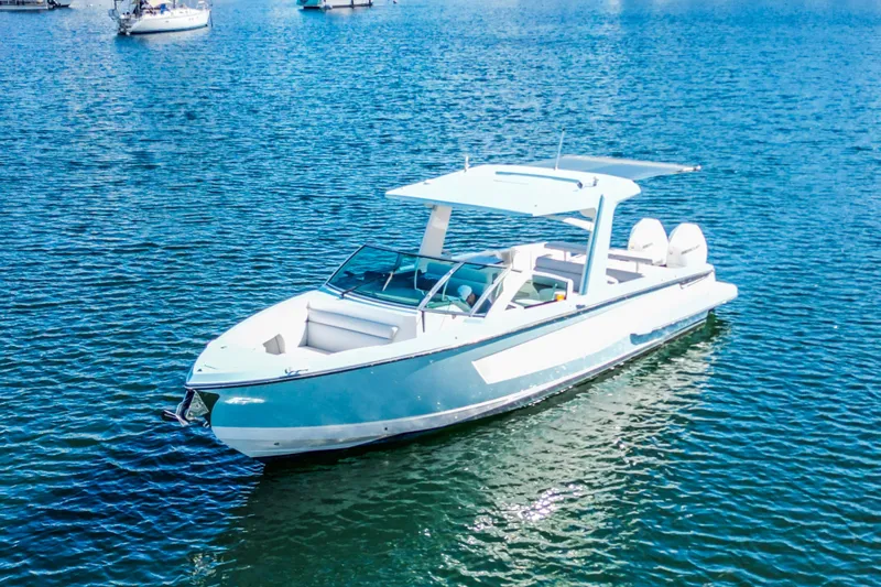  Yacht Photos Pics 2022 Aviara AV32 OB boat on calm blue water, featuring sleek design and modern amenities.