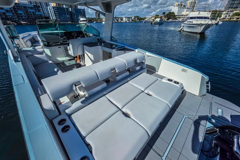  Yacht Photos Pics 2022 Aviara AV32 OB luxury boat with spacious seating on a sunny waterfront.