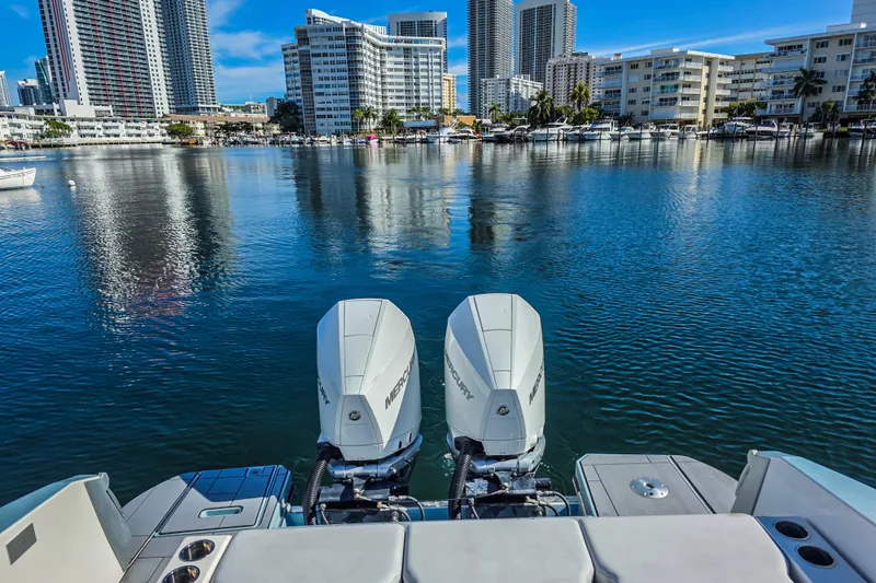  Yacht Photos Pics 2022 Aviara AV32 OB boat with twin Mercury outboards on a city waterfront.