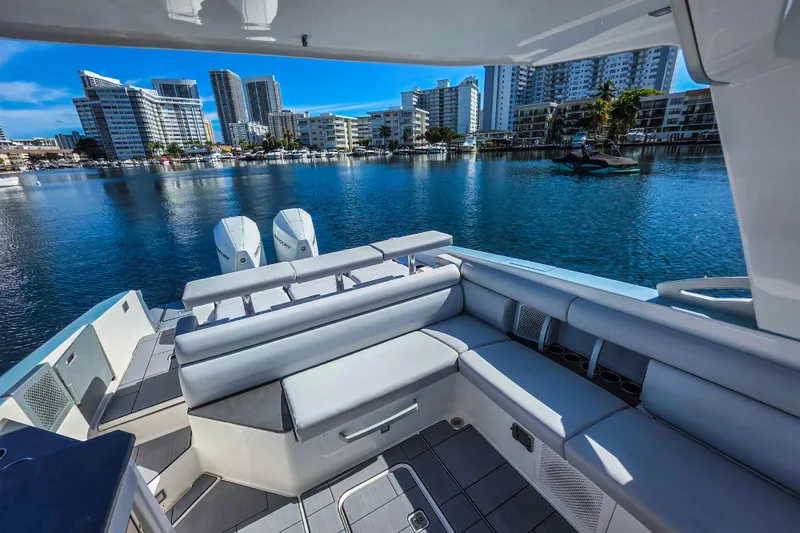 Yacht Photos Pics Luxurious 2022 Aviara AV32 OB boat with spacious seating, docked in a scenic urban marina.