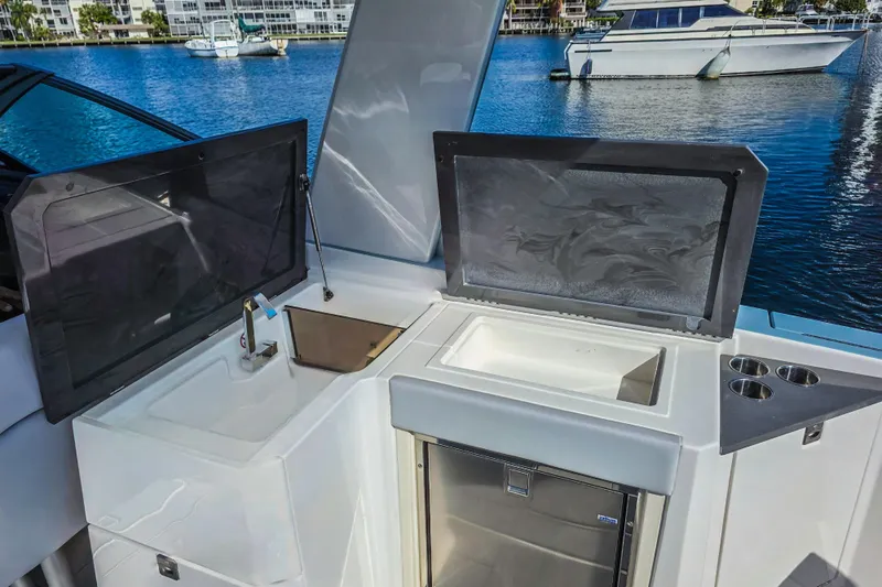  Yacht Photos Pics 2022 Aviara AV32 OB boat kitchen area with sink, storage, and cup holders.