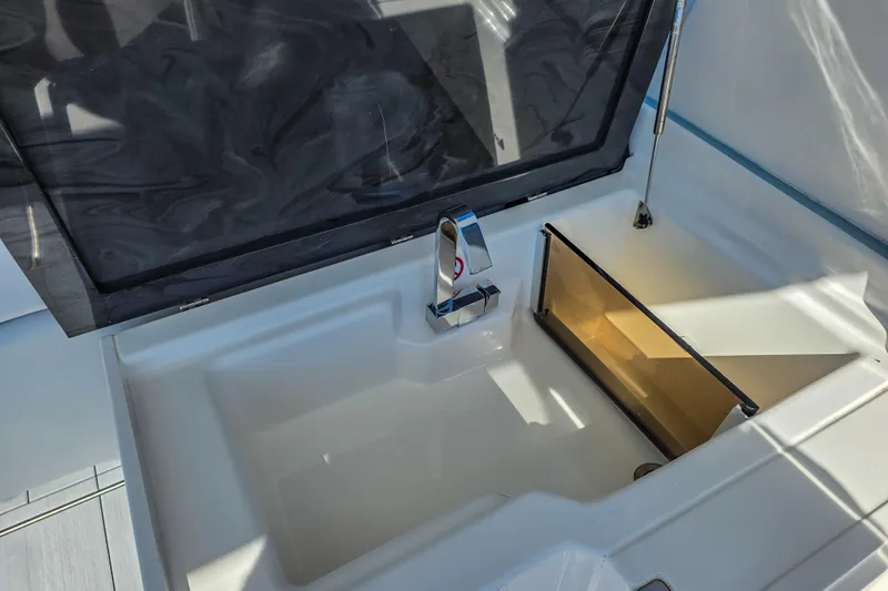  Yacht Photos Pics 2022 Aviara AV32 OB boat sink with modern faucet and storage compartment.