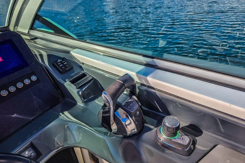  Yacht Photos Pics 2022 Aviara AV32 OB boat cockpit with control panel and throttle on water.